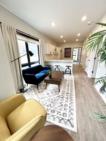 Omaha apartment for rent - A living room with a blue chair and a yellow armchair.
