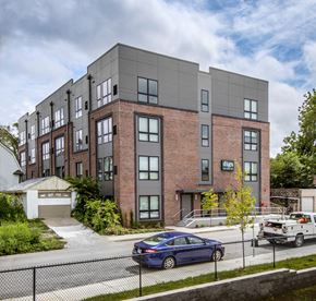 Omaha apartment for rent - a brick building with a car parked in front of it