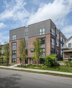 Omaha apartment for rent - a brick building with a sign on the side of a street