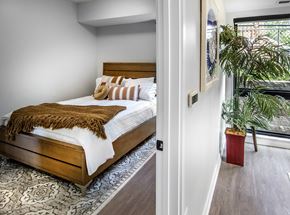 Omaha apartment for rent - a bedroom with a bed and a large window
