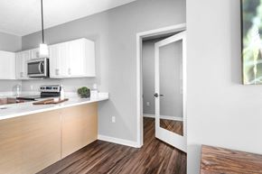 Lincoln apartment for rent - A kitchen with white cabinets and a wooden floor.