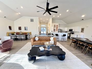 Omaha apartment for rent - A modern living room with a black coffee table in the center.