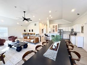 Omaha apartment for rent - A modern dining room with a long table and chairs.