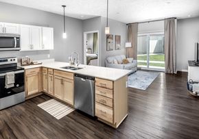 Lincoln apartment for rent - A modern kitchen with wooden cabinets and a large island.