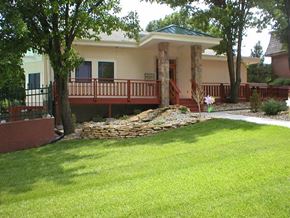 Topeka apartment for rent - The exterior of the Cedar Ridge Apartments clubhouse with green grass in the foreground.