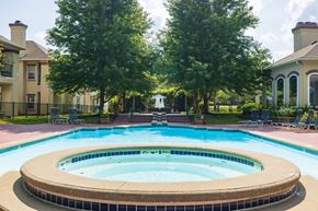 Overland Park apartment for rent - A sparkling swimming pool with the Enclave at Town Center clubhouse in the background.