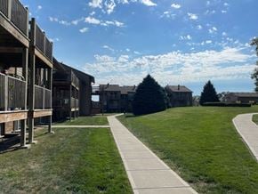 Omaha apartment for rent - Fox Run Apartments community featuring residential buildings, green lawns, and landscaped outdoor spaces.