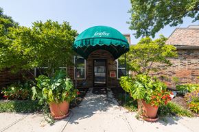Mission townhouse for rent - A welcoming clubhouse with a classic brick exterior and well-kept landscaping.