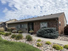 Omaha apartment for rent - Fox Run Apartments leasing office in Omaha, Nebraska with gray roof and front door