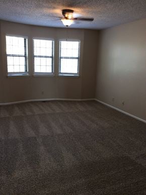 Olathe townhouse for rent - Living room in the Yeakel Townhome, featuring a carpeted floor and a window with blinds.