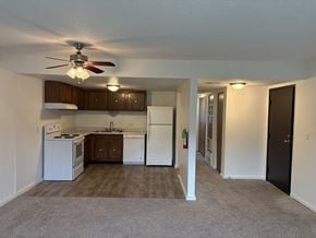 Lawrence townhouse for rent - Vacant apartment kitchen at Park 25 Apartments featuring cabinets, refrigerator, and stove.