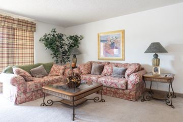 Overland Park townhouse for rent - A living room with a couch, coffee table, and lamp.