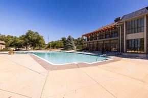 Overland Park apartment for rent - A refreshing swimming pool at Regent’s Walk Apartment Homes, surrounded by lounge chairs and greenery.