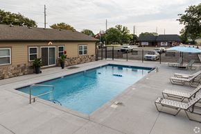 Olathe apartment for rent - Southfork pool with sun loungers, umbrellas, and lounge chairs.