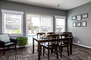 Olathe apartment for rent - A dining room with a table and chairs.