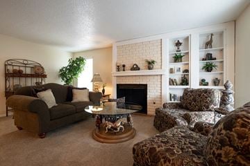 Kansas City townhouse for rent - a living room with couches and chairs and a fireplace