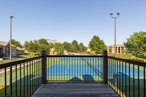 Kansas City apartment for rent - Relax on your apartment unit balcony, offering a perfect view of the community tennis courts.