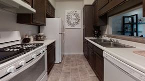 Liberty apartment for rent - Cozy kitchen featuring wooden cabinetry, a stove, and ample counter space, perfect for home cooking.