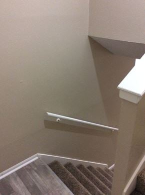 Olathe townhouse for rent - A stairway leading to the upper level of the Yeakel Townhome, with a white handrail.