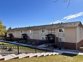 Omaha apartment for rent - Apartment building at Cambridge Apartments with a yard and black wrought iron stair railings.