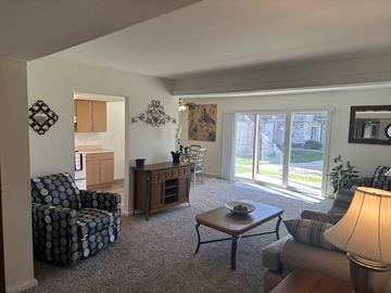 Lawrence townhouse for rent - a living room with a couch and a chair and a table