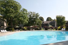 Omaha apartment for rent - A swimming pool with trees and a house in the background at Eden West Apartments.