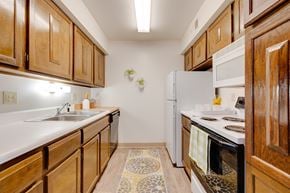 West Des Moines apartment for rent - Kitchen in the two-bedroom model unit at Olde English Village, featuring spacious countertops and practical appliances.