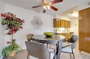 West Des Moines apartment for rent - Dining area in the two-bedroom model unit at Olde English Village, with the kitchen visible in the background.