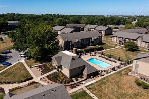 West Des Moines apartment for rent - Aerial view of Olde English Village Apartments with residential buildings, courtyards, and walkways.