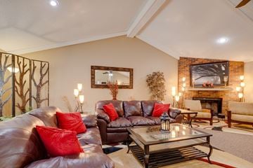 West Des Moines apartment for rent - A living room with a brown leather couch and a glass coffee table.