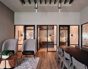 Manor townhouse for rent - A modern dining room with a long table and chairs.