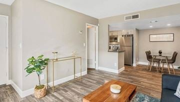 Phoenix apartment for rent - A living room with a blue couch and a wooden coffee table.