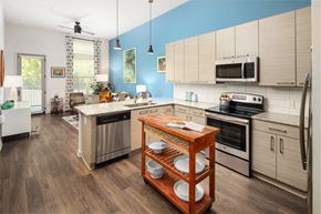 Decatur apartment for rent - a kitchen with white cabinets and stainless steel appliances