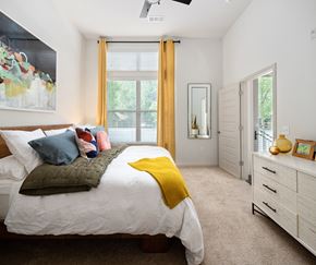 Decatur apartment for rent - a bedroom with a bed and a dresser and a window
