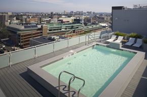 Boston apartment for rent - A rooftop pool with a cityscape in the background.