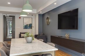 Boston apartment for rent - A modern dining room with a marble table and grey chairs.