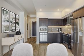 Boston apartment for rent - A modern kitchen with a stainless steel refrigerator and wooden cabinets.