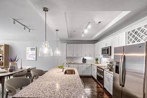 Charlotte apartment for rent - a kitchen with a large island and stainless steel appliances