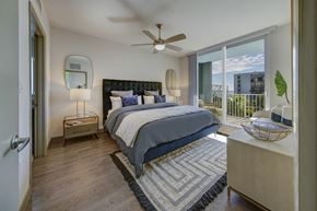 Miami apartment for rent - a bedroom with a large bed and a ceiling fan