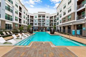 Dallas apartment for rent - a swimming pool in front of an apartment building