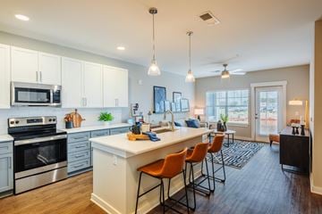 Charlotte apartment for rent - an open kitchen and living room with an island and chairs