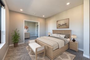 Rochester apartment for rent - a bedroom with a bed and a chair in a room