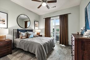 Dallas apartment for rent - a bedroom with a bed and a ceiling fan