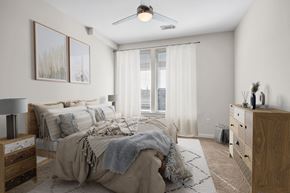 Durham apartment for rent - a bedroom with white walls and a bed with blankets and pillows