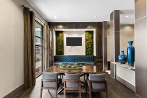 Dallas apartment for rent - a dining room with a table and chairs and a tv on the wall