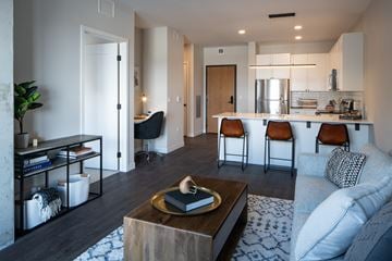 Rochester apartment for rent - A modern living room with a coffee table in the center.