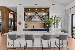Manor townhouse for rent - a kitchen with a marble counter top and bar stools