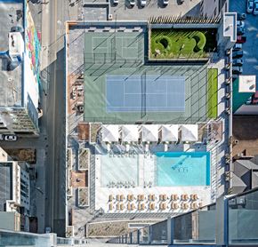 Nashville apartment for rent - A building with a pool and a tennis court on the roof.