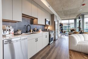 Chicago apartment for rent - A modern kitchen with a stainless steel dishwasher and white cabinets.