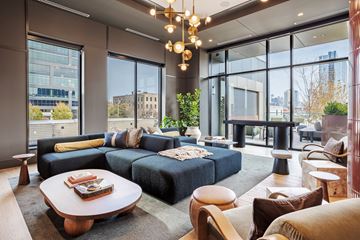 Chicago apartment for rent - A modern living room with a large sectional sofa and a coffee table.